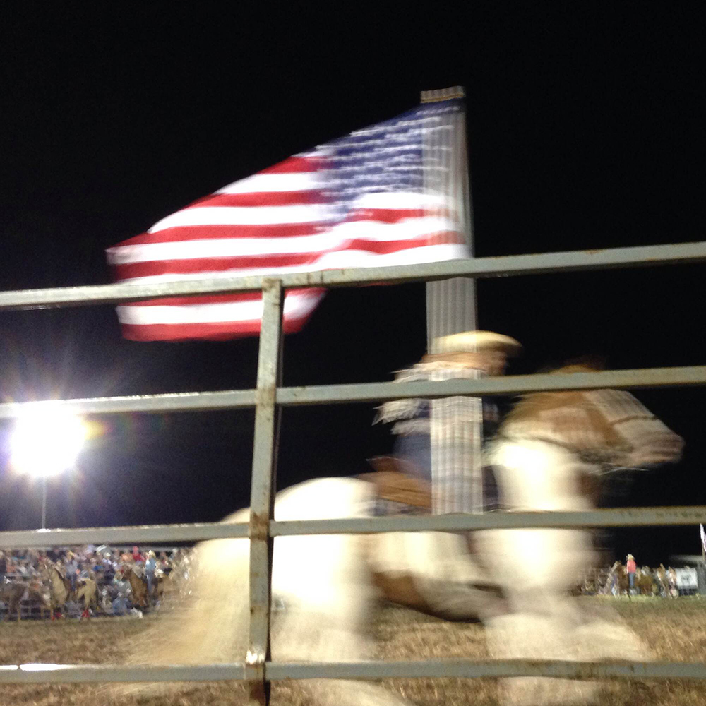 Cowboy with American Flag at Ottowa Farms Rodeo - Hearts and Laserbeams